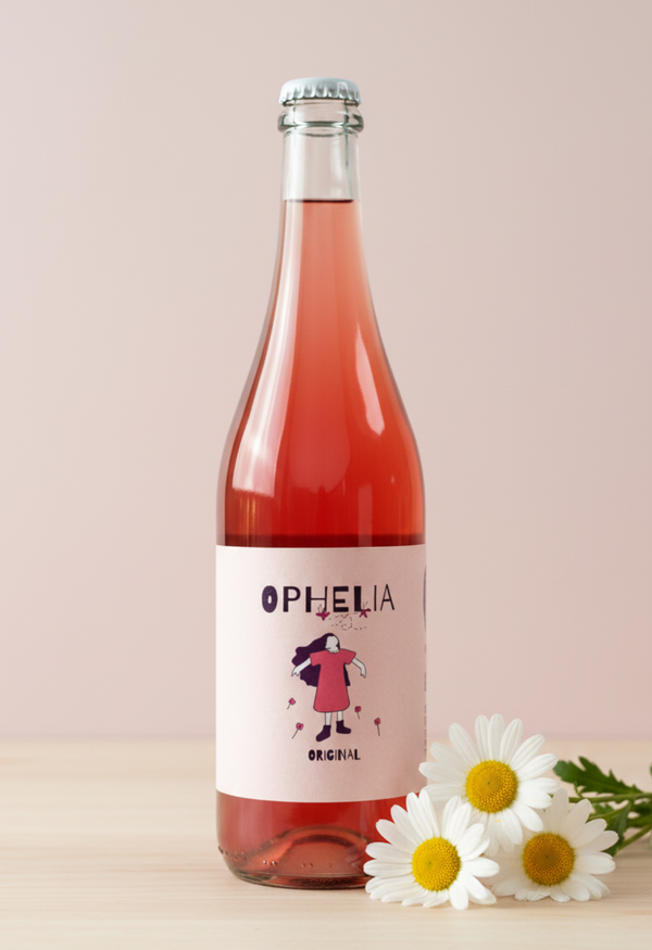 Bottle of Ophelia rosé wine with a label and flowers on a light background
