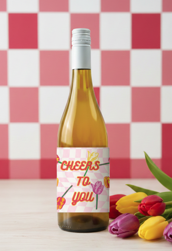 Wine bottle with a decorative label featuring flowers on a checkered background