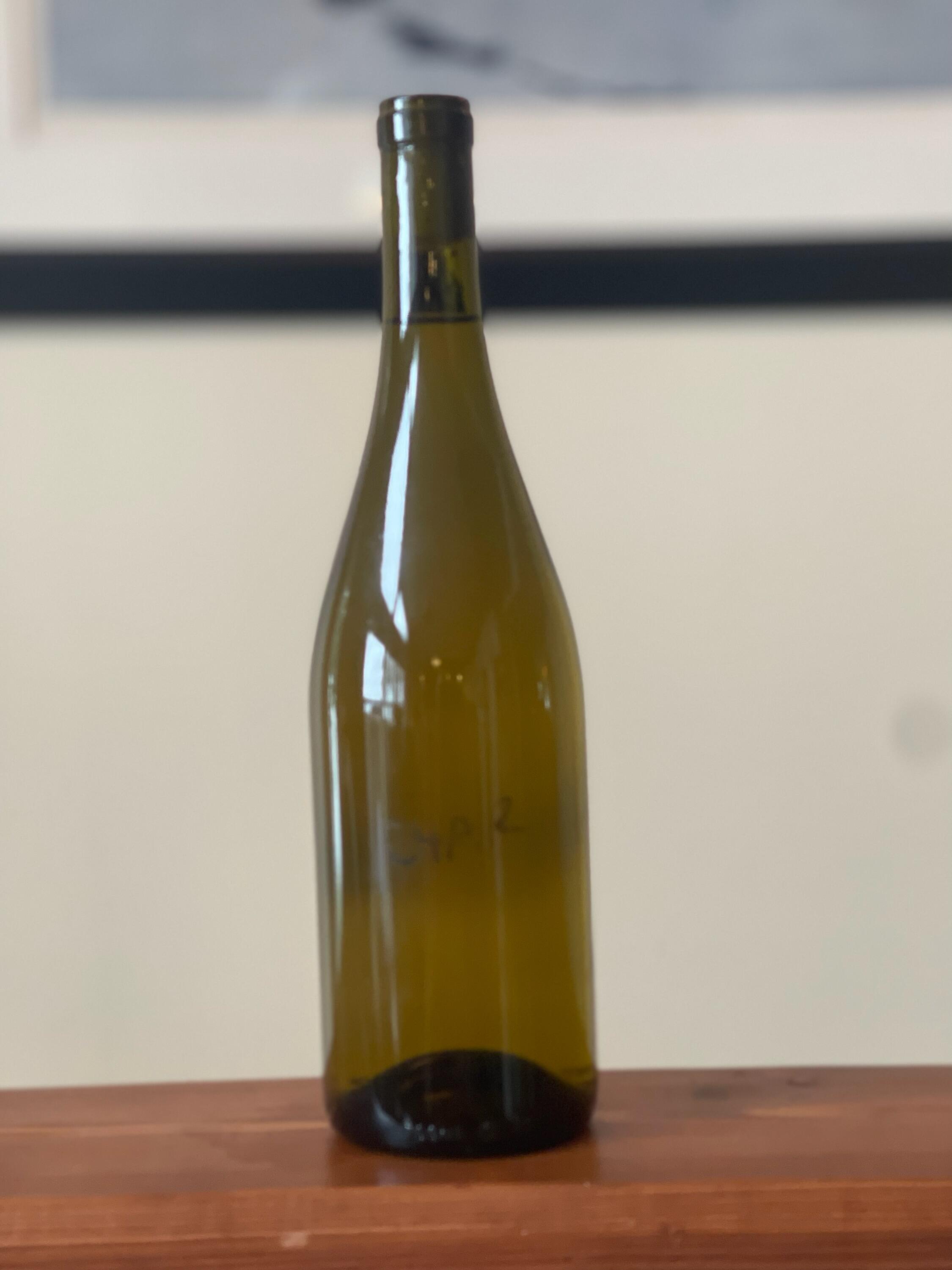 Mystery White (Think Chardonnay) 2014: Bottle shot of an unlabelled Chardonnay with handwritten notes, potentially from the 2014 vintage.