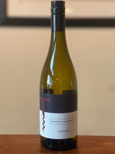 Unoaked Chardonnay 2019: Bottle shot of fresh 2019 Unoaked Chardonnay, a carbonated-style wine from Traynor Family Vineyard.