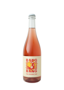 "A bottle of Traynor Family Vineyard's Bang Bang wine with a light pink hue. The label features bold red text 'BANG BANG' with an illustration of a wine bottle bursting like a firework against a yellow and red starburst design. The bottom of the label reads 'VQA Ontario VQA' in red text."