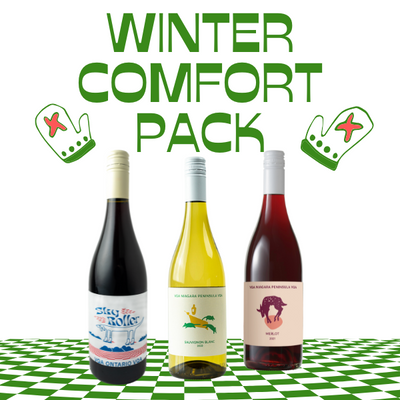 "Winter Comfort Pack featuring three wine bottles displayed on a green-and-white checkered surface. The pack includes a light red, a crisp white, and a smooth Merlot. The text 'Winter Comfort Pack' is written in bold green, accented with mitten graphics for a cozy, winter-themed design."