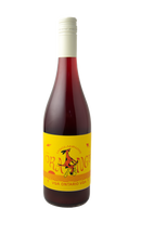 "A bottle of Inclusion Orange wine with a vibrant yellow label. The label features playful red text 'INCLUSION ORANGE' and an illustration of a whimsical red dog riding a bicycle, set against a bold yellow and orange striped background. The bottom of the label reads 'VQA Ontario VQA' in red."