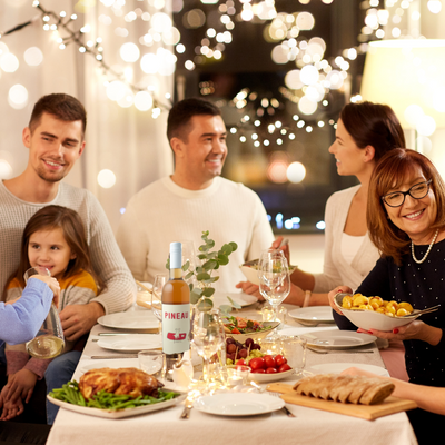 Happy family around a table with wine and food