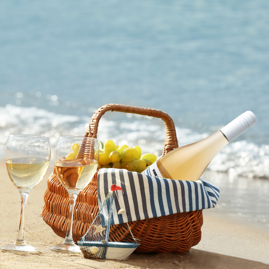 Salt wine in a basket with grapes on a beach