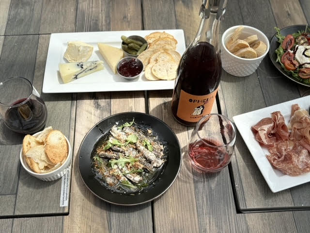 Wine and cheese with meat and wine on a table at Traynor Vineyard